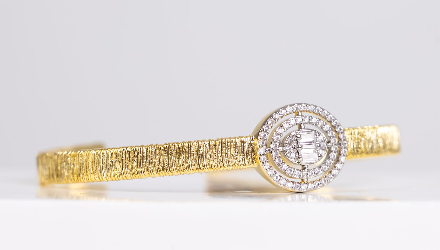 Gold bangle bracelet with silver stone