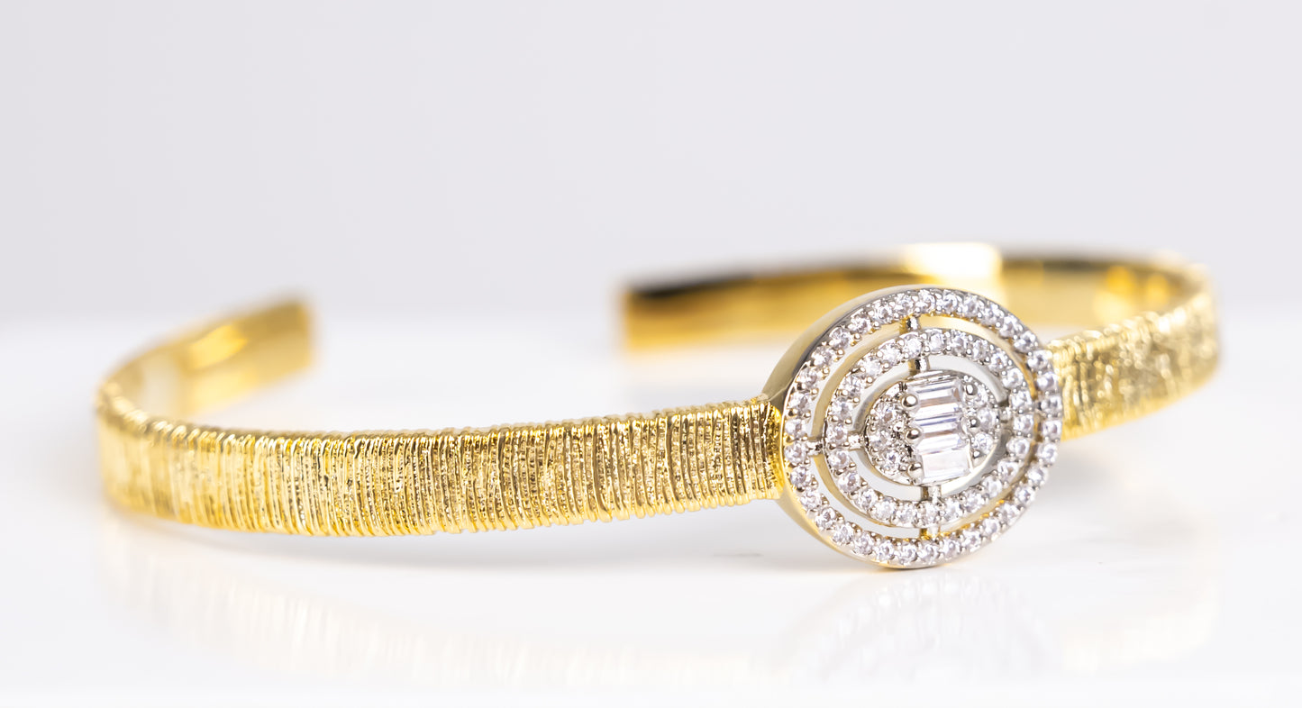 Gold bangle bracelet with silver stone