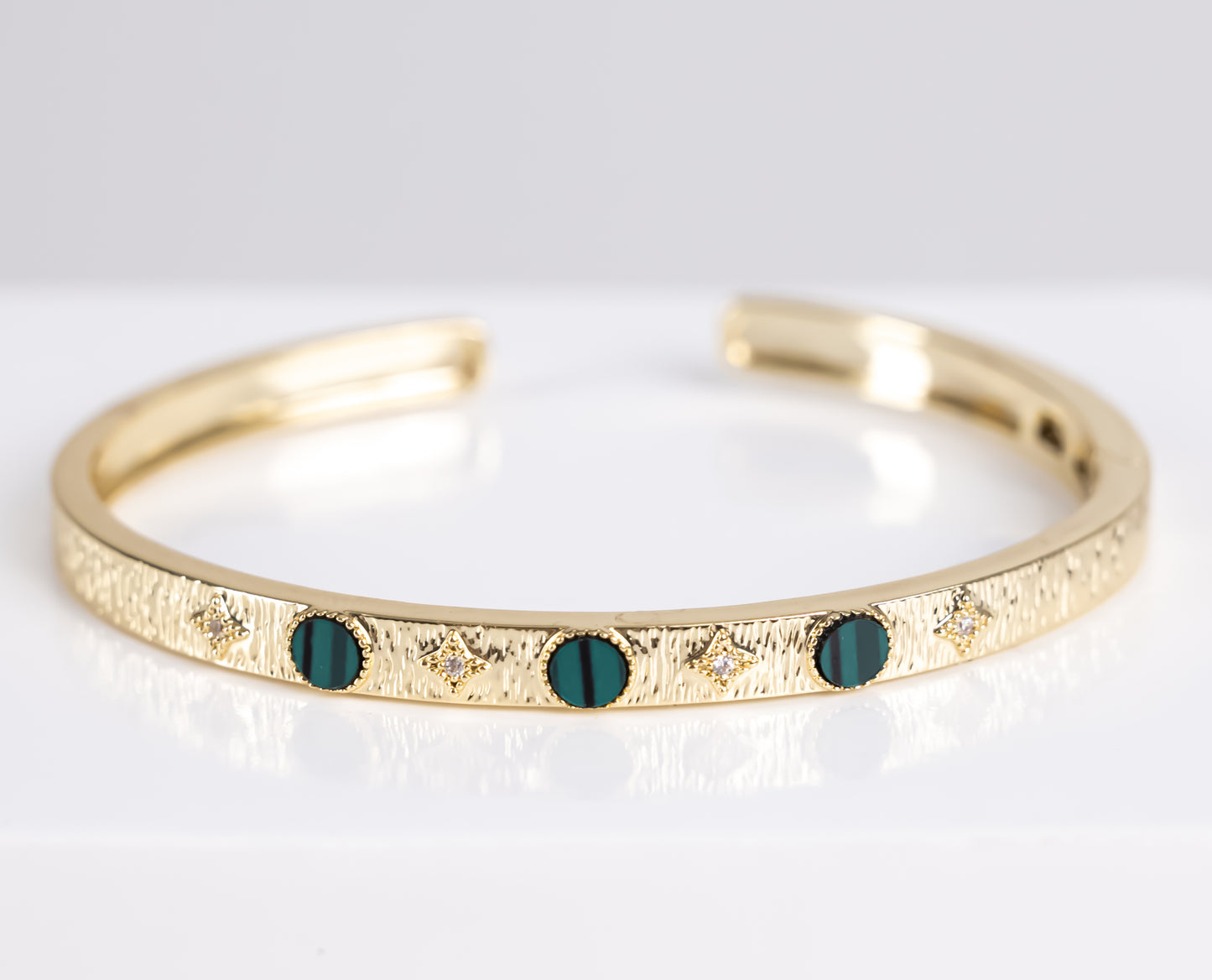 Gold bracelet with green stone