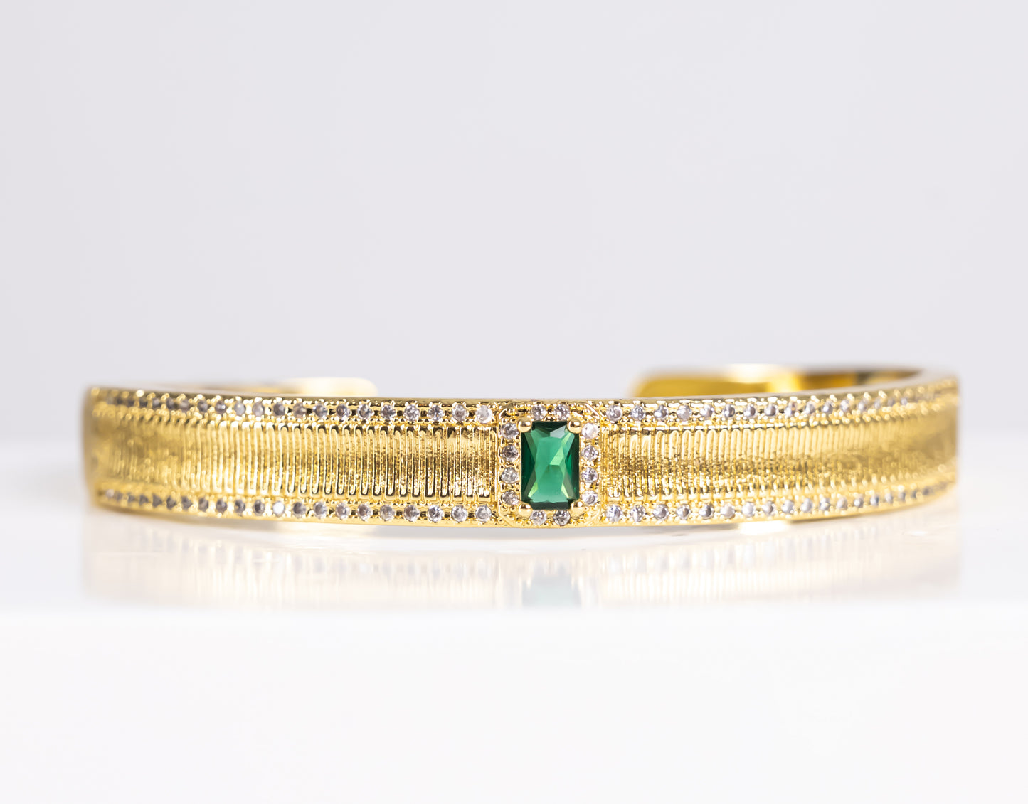 Gold bracelet with green stone
